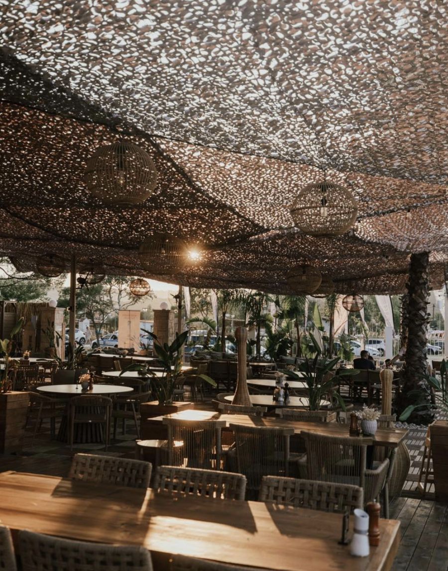 Linari's restaurant terrace under a woven canopy with rattan lanterns