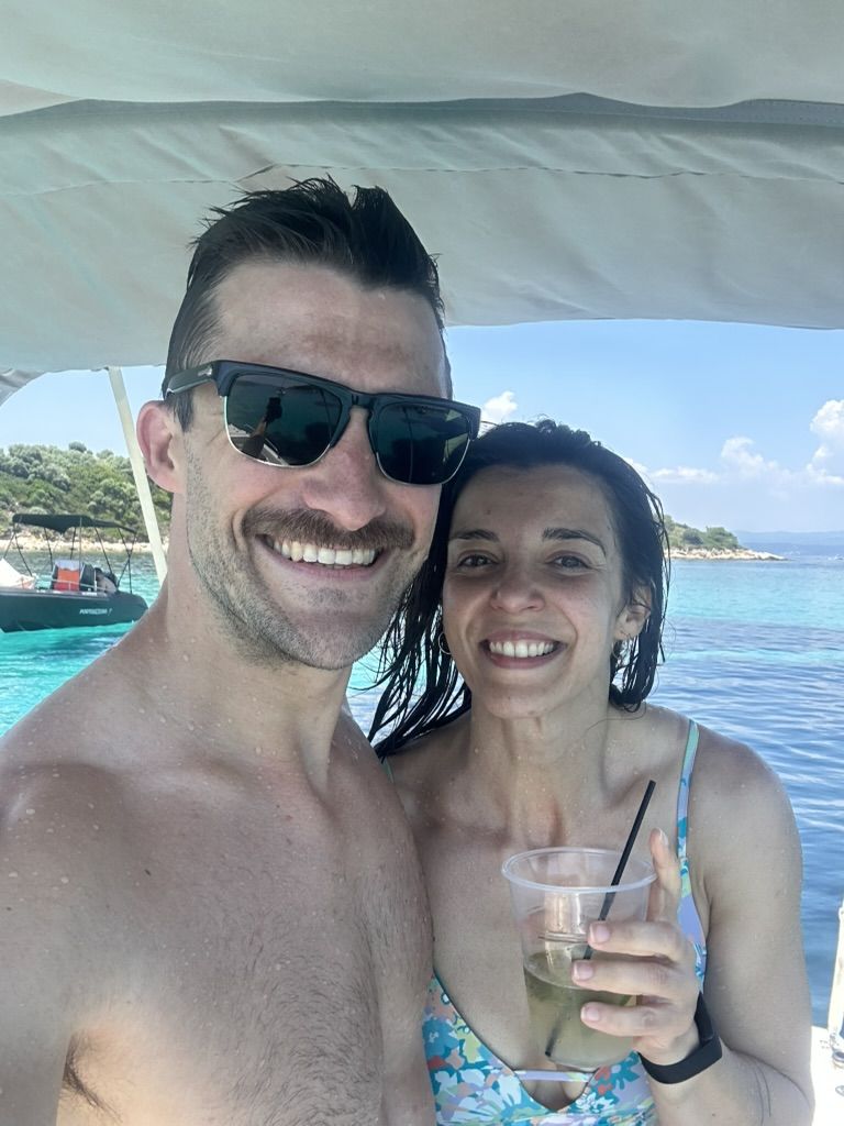 The two of us on a boat in turquoise water off Sithonia